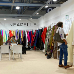 Lineapelle leather trade show person looking at leather on a tannery's stand